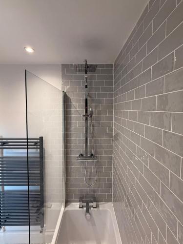 a bathroom with a shower and a bath tub at West Bridgford 2 Bed 2 Bathroom Apartment with parking in West Bridgford