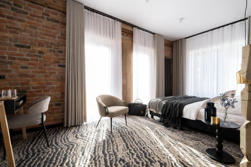 a bedroom with a bed and a brick wall at Kama Lama in Zakopane