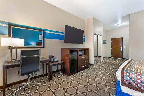 a hotel room with a bed and a desk and a tv at Best Western Sonora Inn & Suites in Nogales