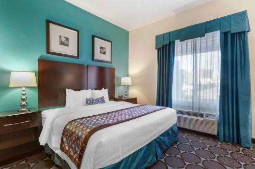 a hotel room with a large bed and a window at Best Western Sonora Inn & Suites in Nogales