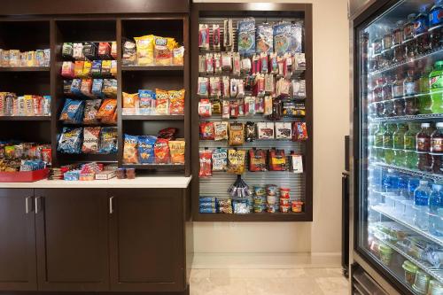 a store aisle with a refrigerator and shelves of food at Delta Hotels by Marriott Orlando Lake Buena Vista in Orlando