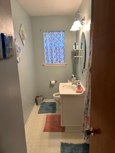 a bathroom with a sink and a toilet and a window at Seacoast Retreat in Long Beach