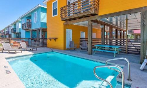 a swimming pool in front of a house at Tequila Sunrise in Port Aransas