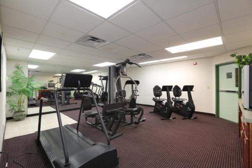 a gym with several tread machines in a room at Allure Suites of Fort Myers in Fort Myers