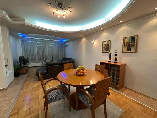 a living room with a table and a couch at Su Apartment in Skopje