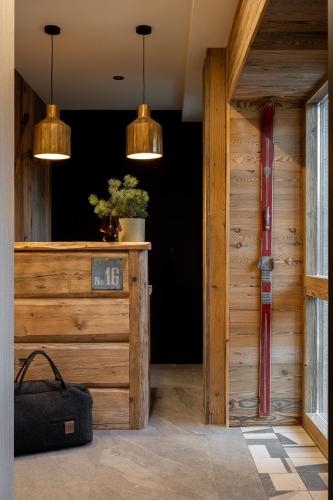 a room with a wooden door with two pendant lights at Kama Lama in Zakopane