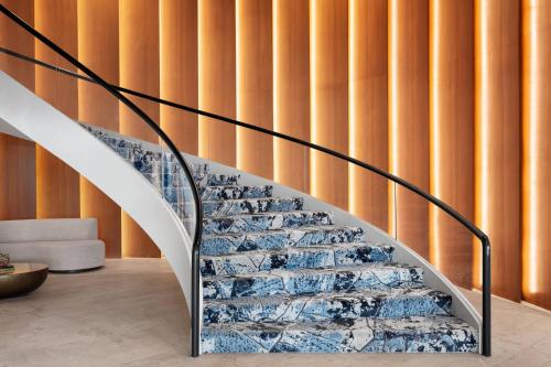 a staircase in a house with a glass wall at Delta Hotels by Marriott™ Virginia Beach Waterfront Suites in Virginia Beach