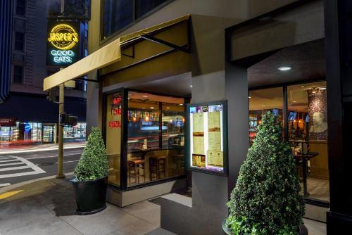 a store front with two christmas trees outside of it at Hotel Spero, Vignette Collection by IHG in San Francisco