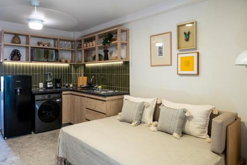 a living room with a bed and a kitchen at Casa Teresa by Barrio México in Guadalajara