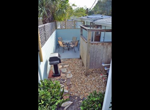 a backyard with a grill and a table on a balcony at One Ocean - A 1101 in Sarasota
