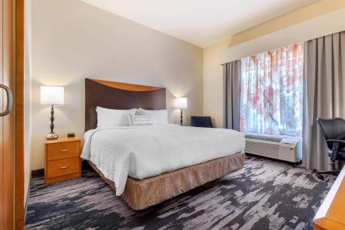 a hotel room with a bed and a large window at Fairfield Inn & Suites by Marriott Rockford in Rockford