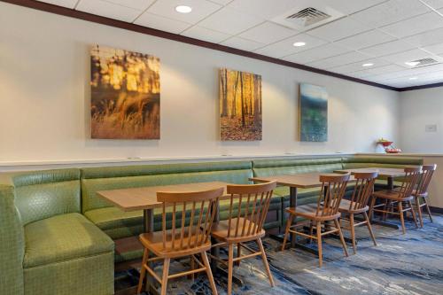 a restaurant with tables and chairs and a couch at Fairfield Inn & Suites by Marriott Rockford in Rockford