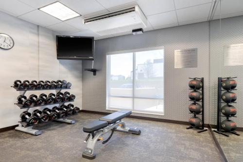 a gym with dumbbells and a window at Fairfield Inn & Suites by Marriott Rockford in Rockford