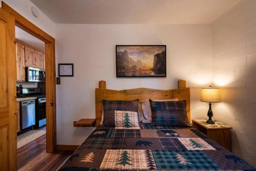 a bedroom with a bed and a kitchen at Whispering Pines in Wawona
