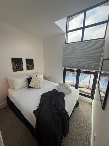 a bedroom with a bed and a large window at Alpenglow Lodge by Elevate Vacations in Whistler