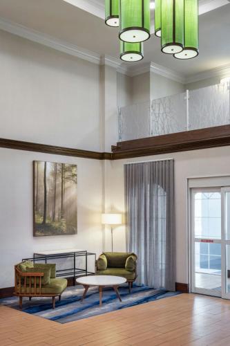 a living room with a couch and a table at Fairfield Inn & Suites by Marriott Charleston North/Ashley Phosphate in Charleston