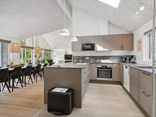 a kitchen and dining room with a table and chairs at 5 star holiday home in Otterup in Otterup