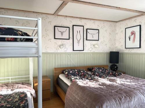 a bedroom with a bunk bed and some pictures on the wall at 10 person holiday home in BÄCKEFORS in Bäckefors