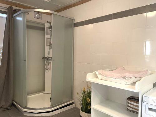 a shower with a glass door in a bathroom at 10 person holiday home in BÄCKEFORS in Bäckefors