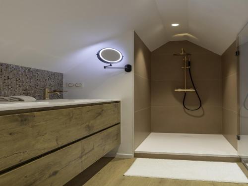 a bathroom with a sink and a shower at A charming holiday home with a swimming pool in Belleghem