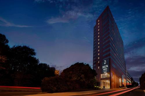 a tall building with a sign in front of it at Delta Hotels by Marriott Richmond Downtown in Richmond