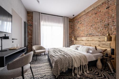 a bedroom with a brick wall and a bed at Kama Lama in Zakopane