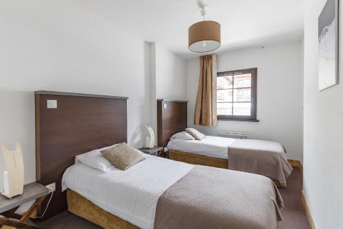 מיטה או מיטות בחדר ב-Lagrange Vacances Les Fermes Emiguy