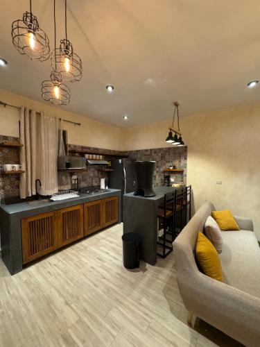 a living room with a couch and a kitchen at Casa Grande de lujo cerca de Antigua Guatemala in Antigua Guatemala