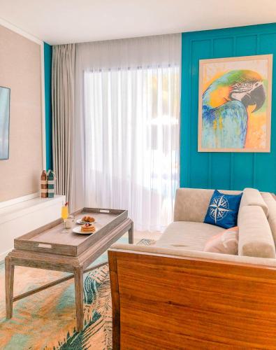 a living room with a couch and a table at Margaritaville Island Reserve Riviera Cancún - A Karisma All-Inclusive Experience for All in Puerto Morelos