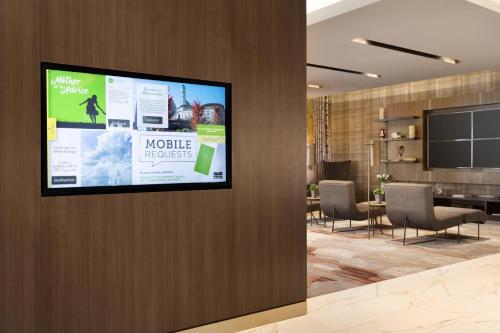 a flat screen tv on a wall in a lobby at Courtyard by Marriott Toronto Mississauga/West in Mississauga