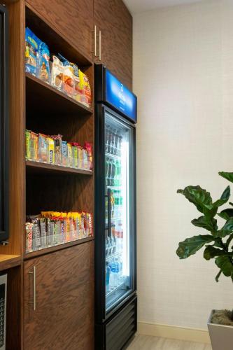 a refrigerator in the corner of a room at Delta Hotels by Marriott Indianapolis Airport in Indianapolis