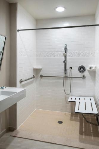 a bathroom with a shower and a sink at Delta Hotels by Marriott Basking Ridge in Basking Ridge