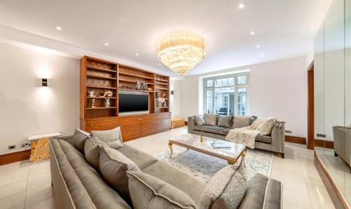 a living room with a couch and a tv at 250 SqM MEGA MANSION in London