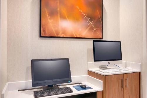 a desk with a computer and a monitor and keyboard at Fairfield Inn & Suites by Marriott Rockport in Rockport
