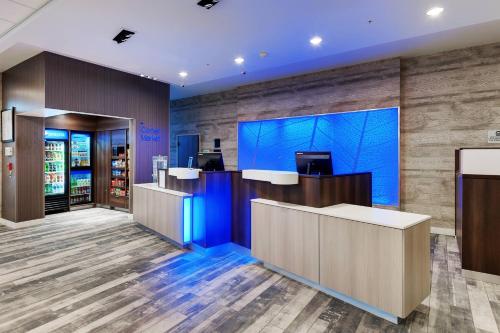 a lobby of a store with a blue wall at Fairfield Inn & Suites by Marriott Chicago Schaumburg in Schaumburg
