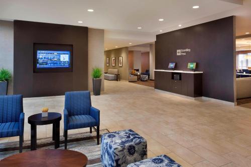 a lobby of a hospital with blue chairs and a desk at Courtyard by Marriott Toronto Northeast/Markham in Markham