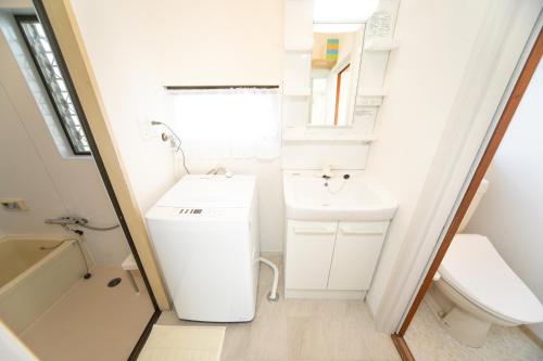 a small bathroom with a sink and a toilet at Miraie Yokkaichi Nishishinchi 2 in Yokkaichi
