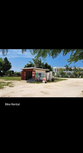 a building in the middle of a dirt road at Rest Studio Apartment in Dambani