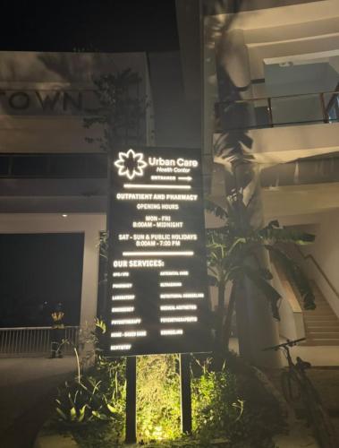 a sign in front of a building with a plant at Rest Studio Apartment in Dambani