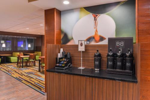 a lobby with a bar with bottles of wine at Fairfield Inn & Suites by Marriott Coralville in Coralville
