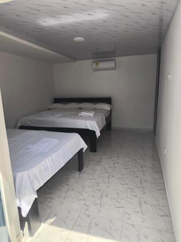 a room with two beds in a room with at Villas Campestres las Heliconias in Villavicencio