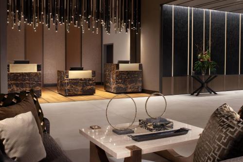 a living room with a table and chairs at Delta Hotels by Marriott Dallas Southlake in Southlake