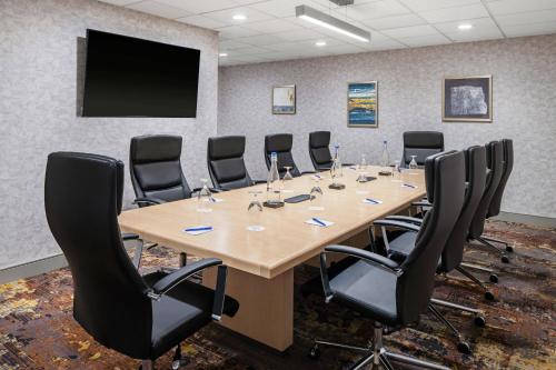 a conference room with a large wooden table and chairs at Delta Hotels by Marriott Green Bay in Green Bay