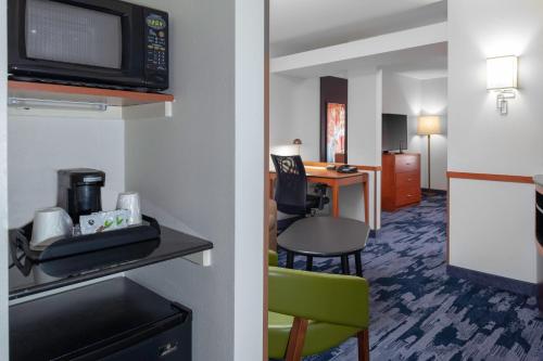 a hotel room with a living room and a dining room at Fairfield Inn & Suites by Marriott Matthews Charlotte in Charlotte