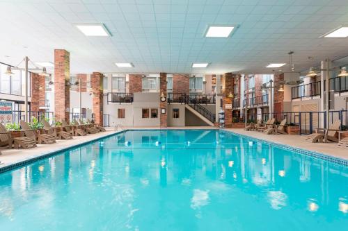 a large swimming pool with blue water in a building at Delta Hotels by Marriott Kalamazoo Conference Center in Kalamazoo