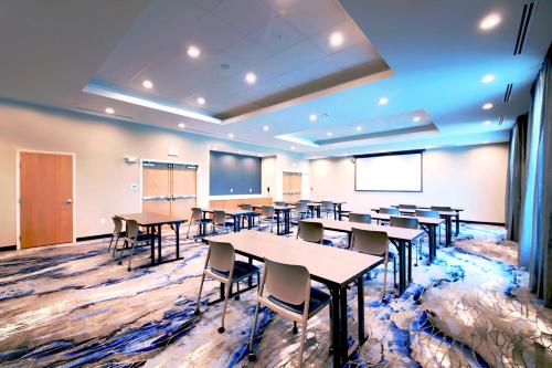 a classroom with tables and chairs and a projection screen at Fairfield Inn & Suites by Marriott Dallas Cedar Hill in Cedar Hill
