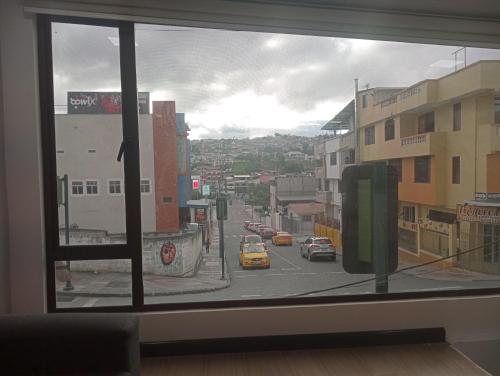a view of a city street from a window at Mini suit in Loja
