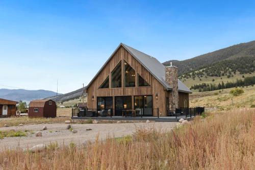 a large wooden house in the middle of a field at BHA - Luxury A-Frame in Creede