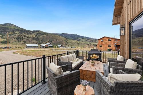 a patio with chairs and a fire pit on a deck at BHA - Luxury A-Frame in Creede