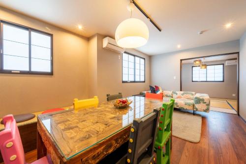 a living room with a table and a couch at 臨空の宿 MARUYA Izumisano in Izumi-Sano